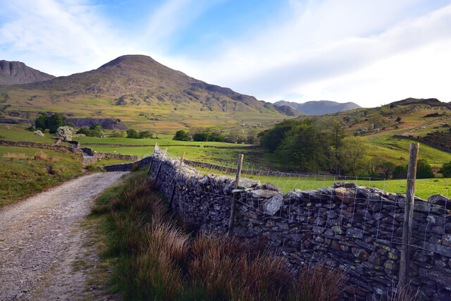 A gravel trail leading toward the old man of coniston mountain