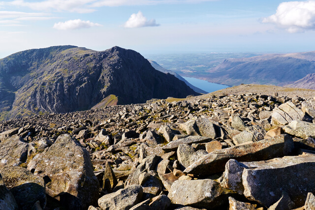 A view of the surrounding mountains and the rocky terrain from the top of Scafell Pike