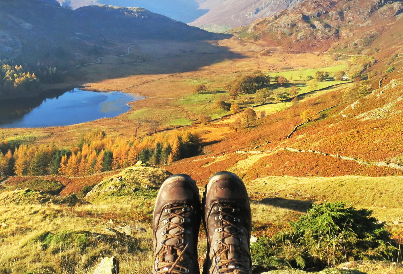 Walking boots with a background of the countryside in autumn