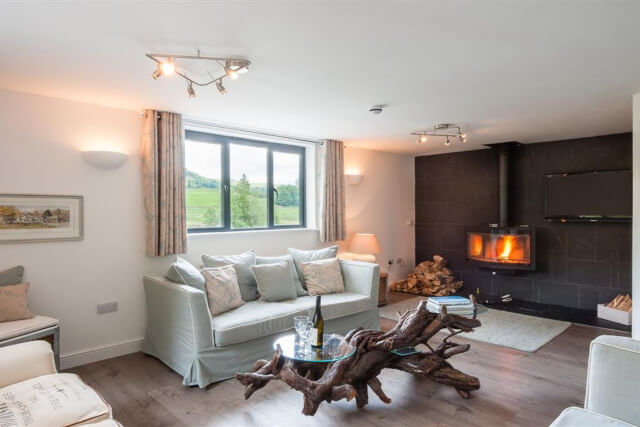 An interior shot of the living room and woodburner at Le Chalet