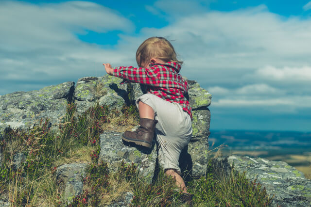 A child climbing a rock