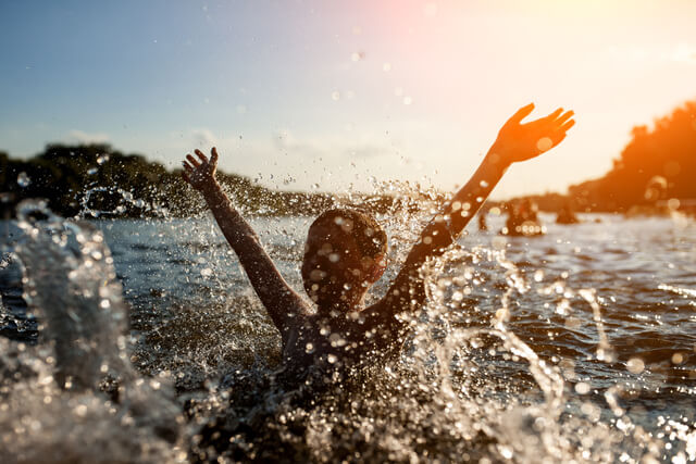 A child making a splash in the river