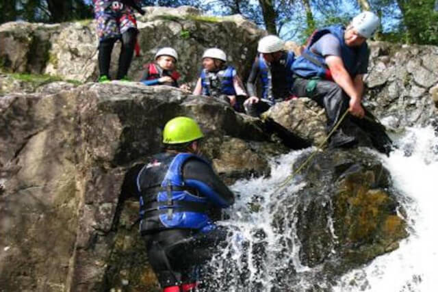 A group of people ghyll scrambling in the Lake District 