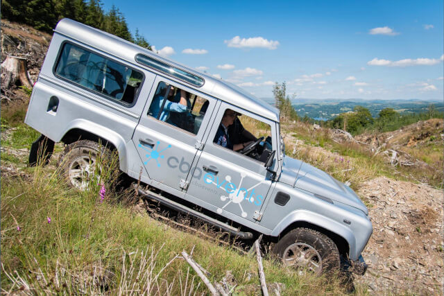 A silver CBA events 4x4 car driving through the countryside