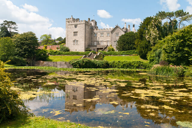 A front facing view of a pond and Sizergh Castle