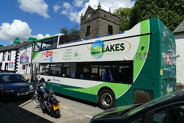 A green open top bus in the Lake District