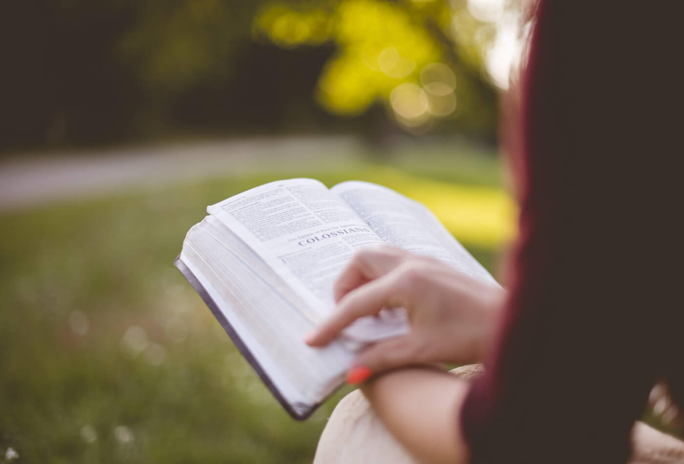 A woman reading a book outdoors