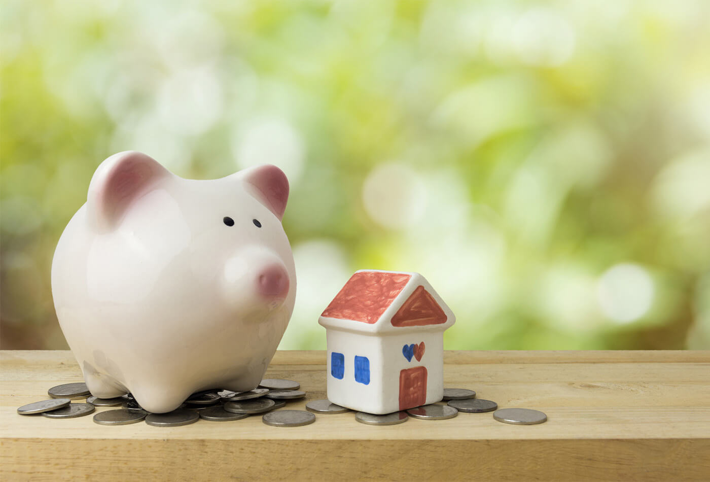 A piggy bank sat on a number of coins