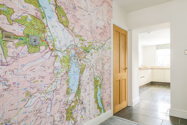 A wall in a house with a map hung as wallpaper