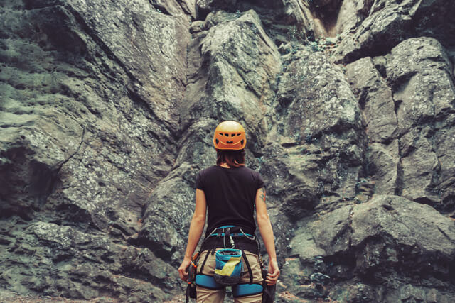 A woman outdoor rock climbing