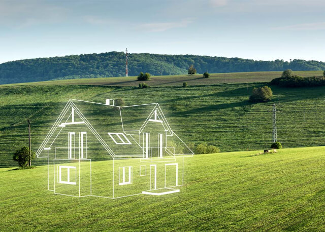 Outline of a house on green fields