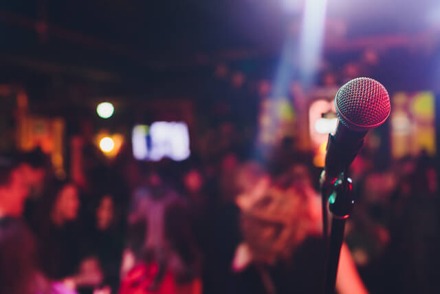 A microphone on stage at a busy live music bar