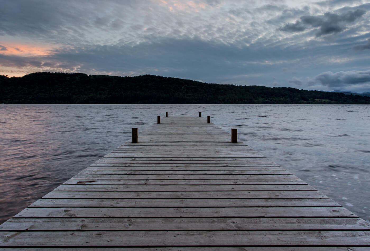 A view across Lake Windermere from a wooden jetty