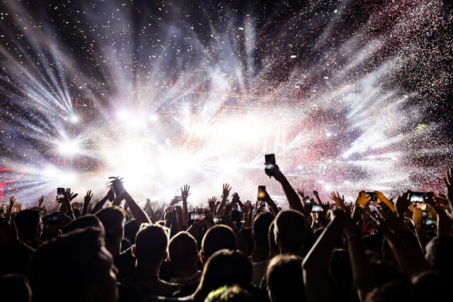 Confetti and lights on stage at a festival at night