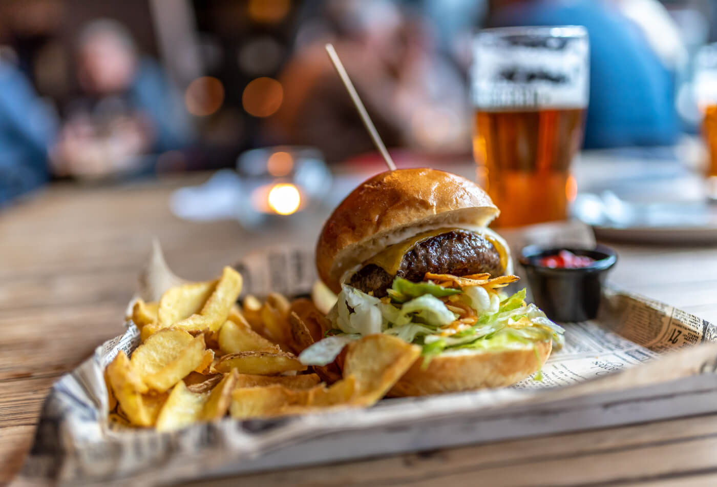 A burger and chips on a plate in a restaurant