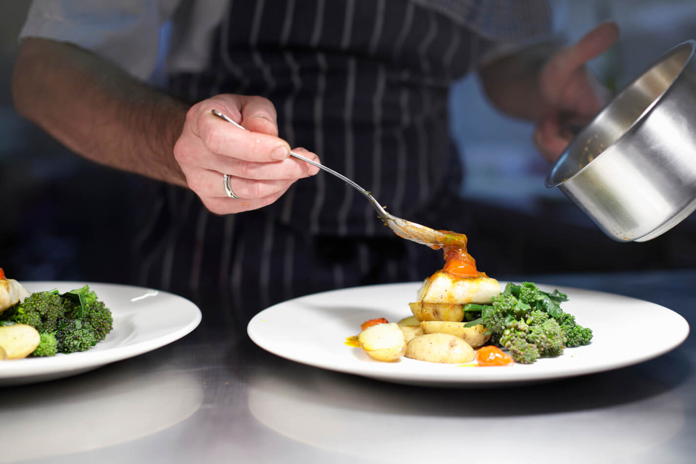 A chef preparing a dish in a kitchen