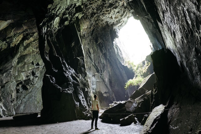 A person standing in the middle of the main chamber in cathedral cavern