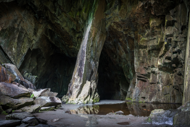 A photo of the rocky and slate interior of Cathedral Cave in Little Langdale
