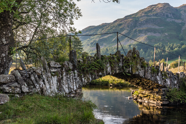 Moss on the rocks of slaters bridge crossing over a river in the Langdale Valley