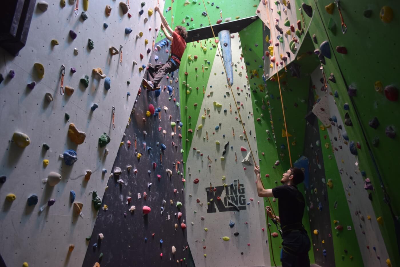 Child on Rock climbing wall with instructor 