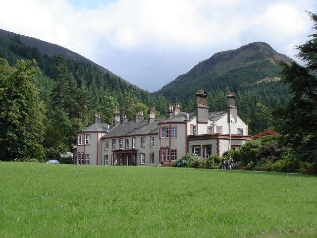 An exterior photograph of Mirehouse and its surrounding gardens