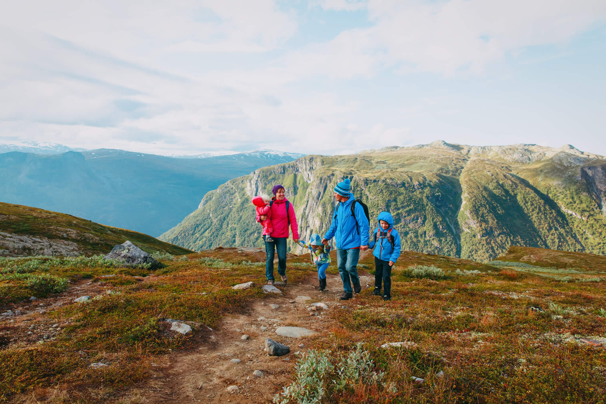 happy family with kids hiking in mountains, travel concept